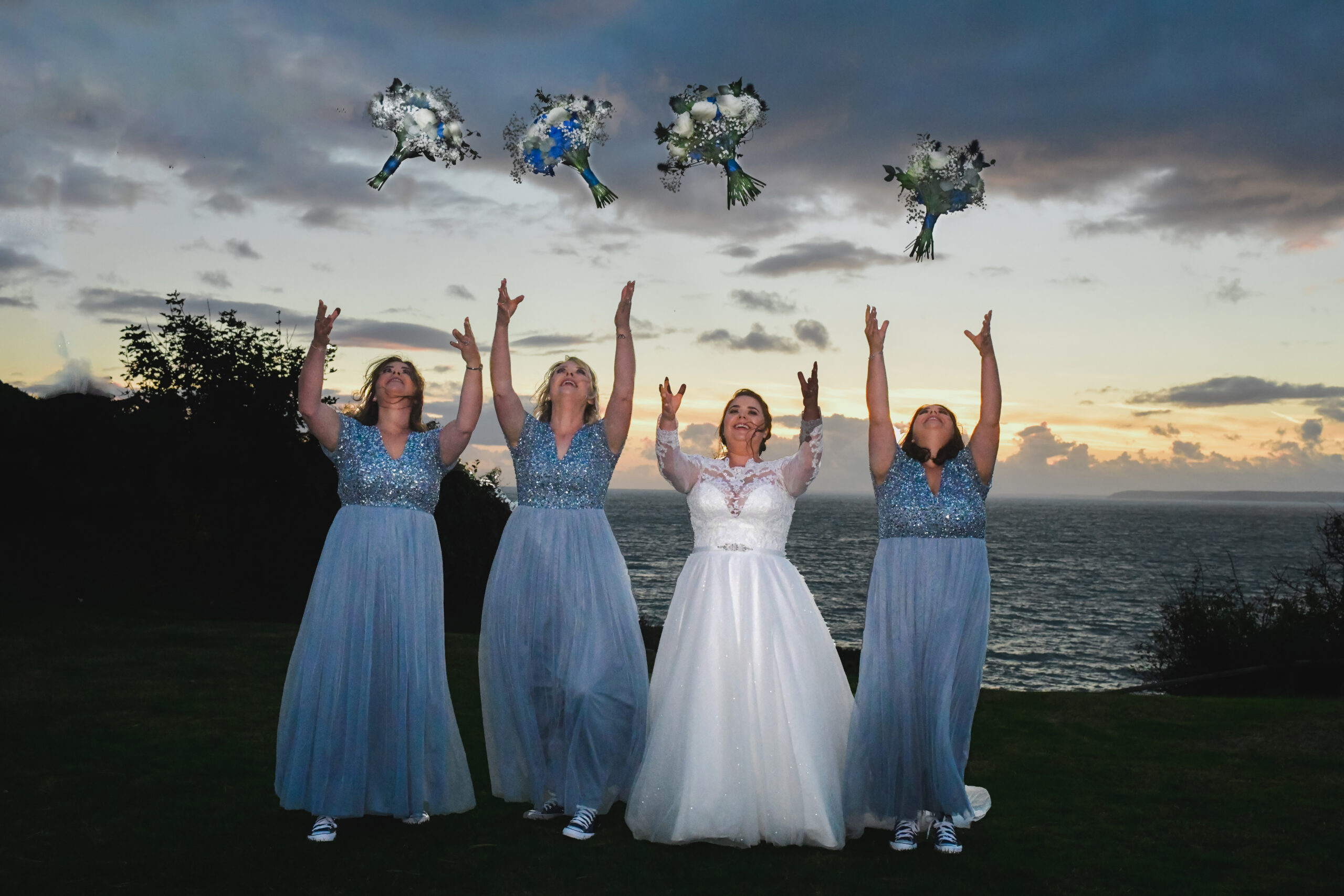 Sunset Wedding Photography at Polhawn Fort the Bridemaids throwing the Bouquet Award winning Wedding Photography at Polhawn Fort