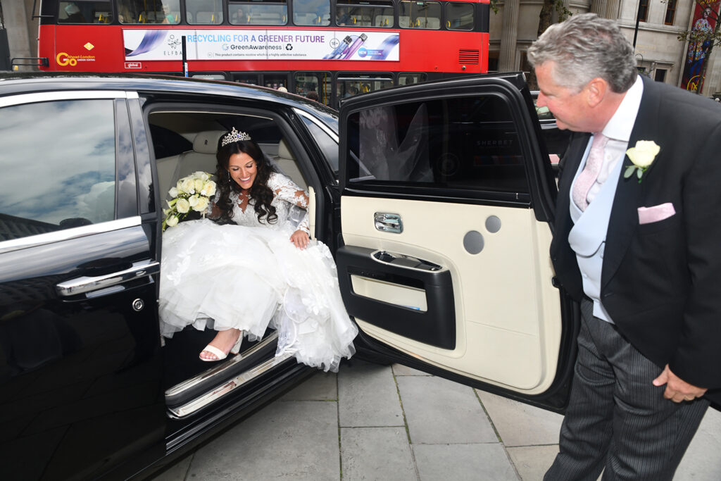 Wedding Photographer of the brides arrival in the Savoy hotel Rolls Royce at St Martins in the Fields